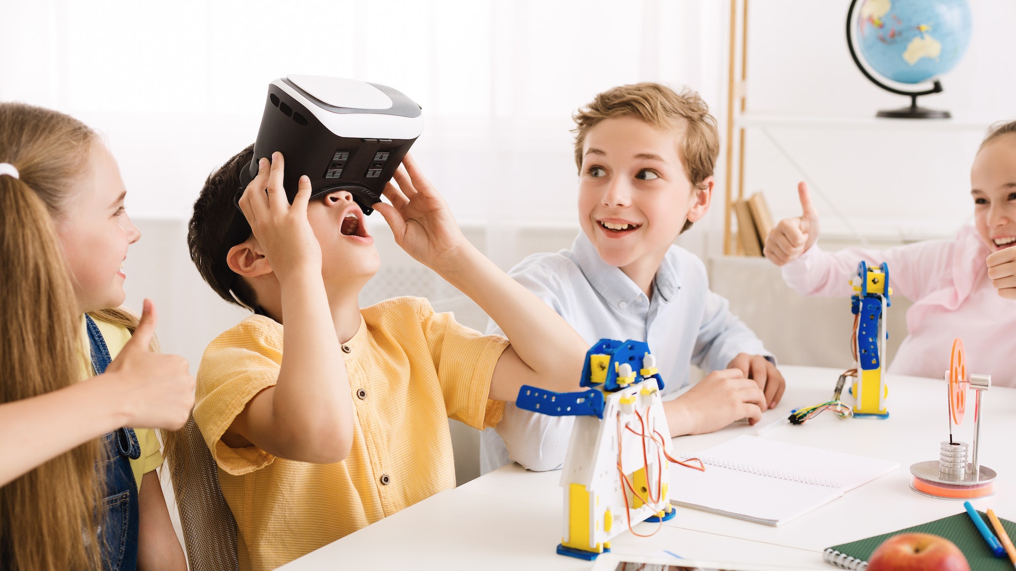 Schoolboy playing with vr glasses in classroom